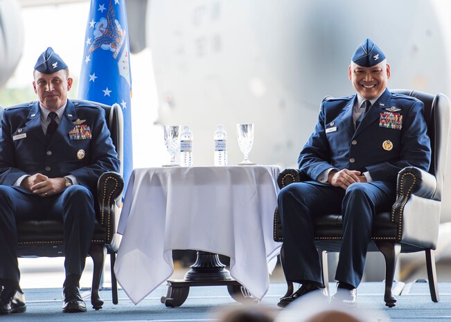 Colonel Jimmy Canlas (right) and Col. John Lamontagne smile during the 437th Airlift Wing change of command June 24, 2016, in Nose Dock 2 at Joint Base Charleston - Air Base, S.C. Canlas, the new 437th AW commander, is a native of Port Hueneme, Calif. He graduated from the University of Texas at San Antonio in 1992 and was commissioned as a Second Lieutenant in the U.S Air Force. A command pilot with more than 4,100 hours in the C-21A, KC-135R Stratotanker and C-17A Globemaster III aircraft, Canlas served as the vice commander, 437th AW, prior to taking command. (U.S. Air Force photo/Staff Sgt. Jared Trimarchi)