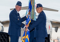 Colonel Jimmy Canlas (right) accepts the 437th Airlift Wing guidon from Lt. Gen. Samuel D. Cox, 18th Air Force commander, during the 437th AW change of command ceremony June 24, 2016, in Nose Dock 2 at Joint Base Charleston - Air Base, S.C. The guidon is a source of pride for the wing and its exchange symbolizes the end of an era as well as the beginning of a new one.  Canlas, a native of Port Hueneme, Calif., graduated from the University of Texas at San Antonio in 1992 and was commissioned as a Second Lieutenant in the U.S Air Force. (U.S. Air Force photo/Staff Sgt. Jared Trimarchi)