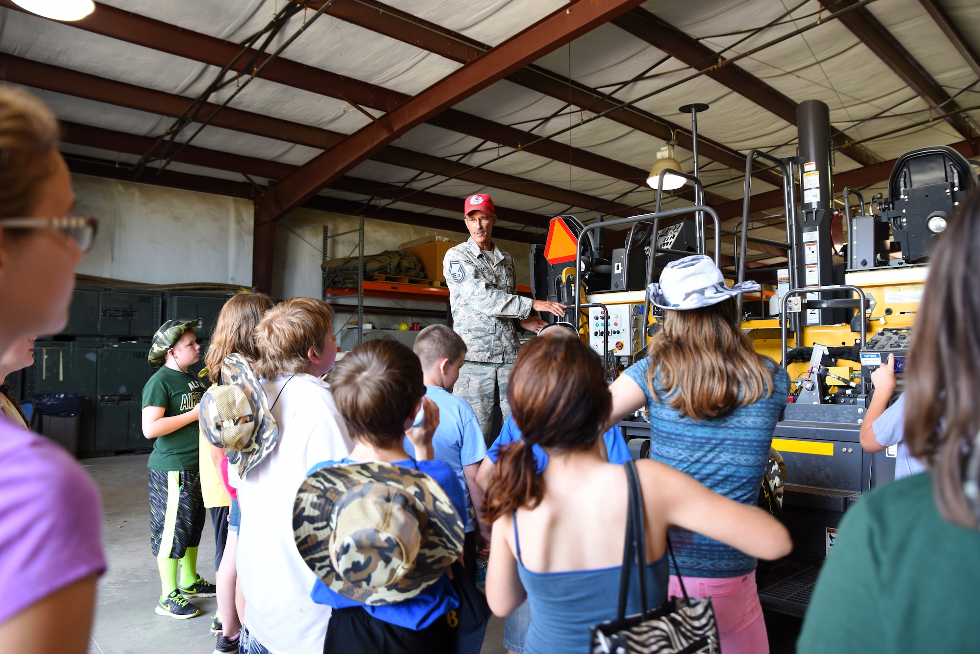 Senior Master Sgt. Robert Haag II, rapid engineer deployable heavy operational repair squadron engineer (REDHORSE) training center senior instructor, shows students of the Alma School District how to mix asphalt June 8, 2016, during their tour of the 188th Wing at Ebbing Air National Guard Base, Fort Smith, Ark. The students are part of an Alma School District learning program called Camp Airedale that has a curriculum centered on experience-based activities and uses out-of-classroom and off-campus activities than are available during the typical school year. (U.S. Air National Guard photo by Senior Airman Cody Martin/Released)