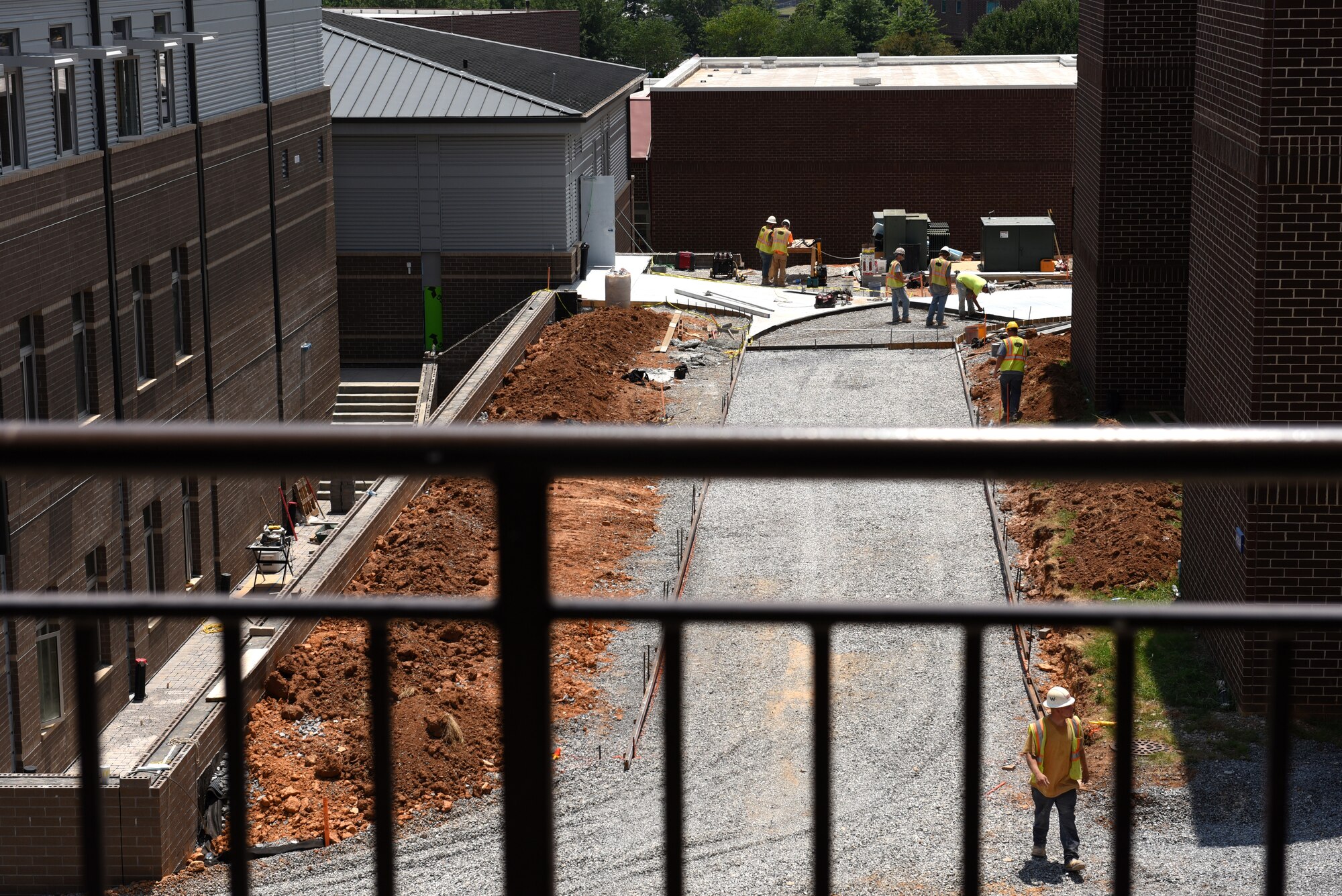 Workers build forms and pour a concrete sidewalk leading from the billeting office to Spruance Hall (in the background) June 13, 2016, among other interior and exterior projects on the new facility at the I.G. Brown Training and Education Center in Louisville, Tenn. (U.S. Air National Guard photo by Master Sgt. Mike R. Smith/Released)