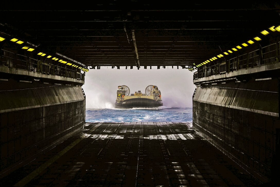 160618-N-OF476-140

ARABIAN GULF (June 18, 2016) A landing craft air cushion prepares to enter the well deck of amphibious assault ship USS Boxer in the Arabian Gulf, June 18, 2016. The Boxer is supporting maritime security operations and theater security cooperation efforts in the U.S. 5th Fleet area of operations. Navy photo by Seaman Eric Burgett