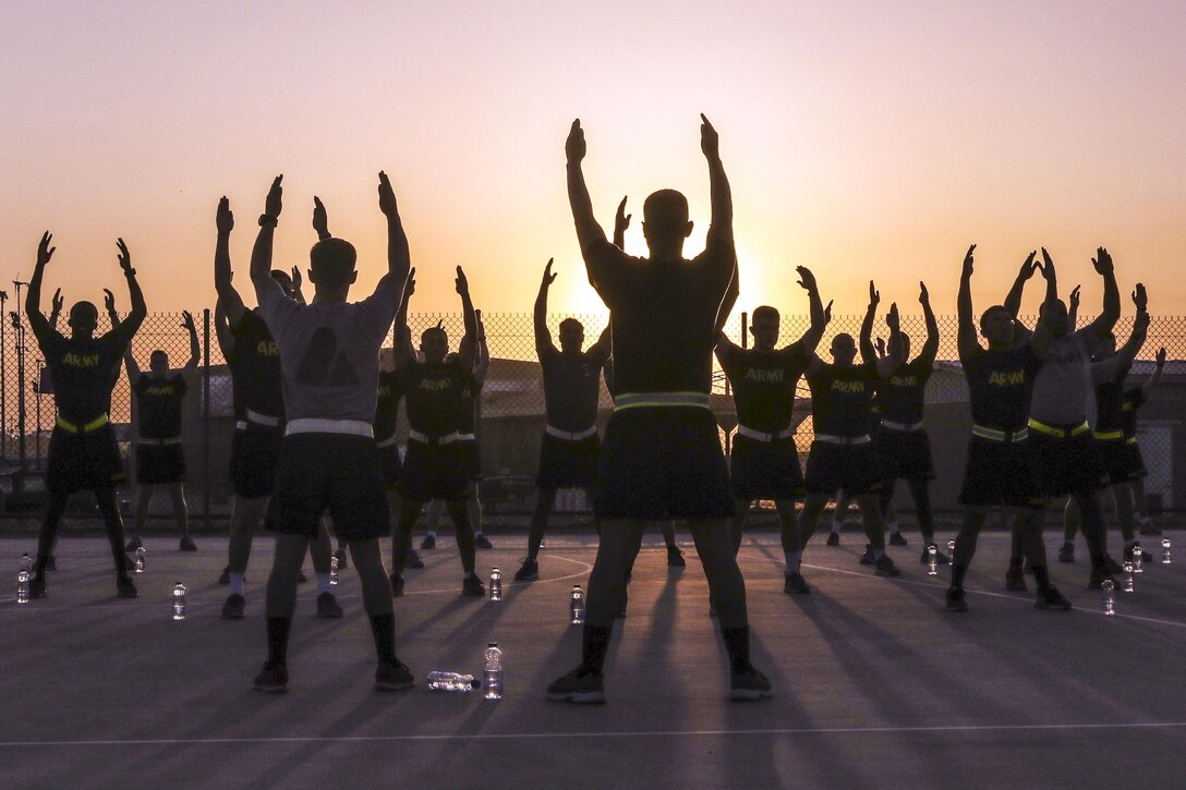 Soldiers stretch during sunrise before an early morning run at Camp Arifjan, Kuwait, June 13, 2016. Army photo by Sgt. Brandon Hubbard