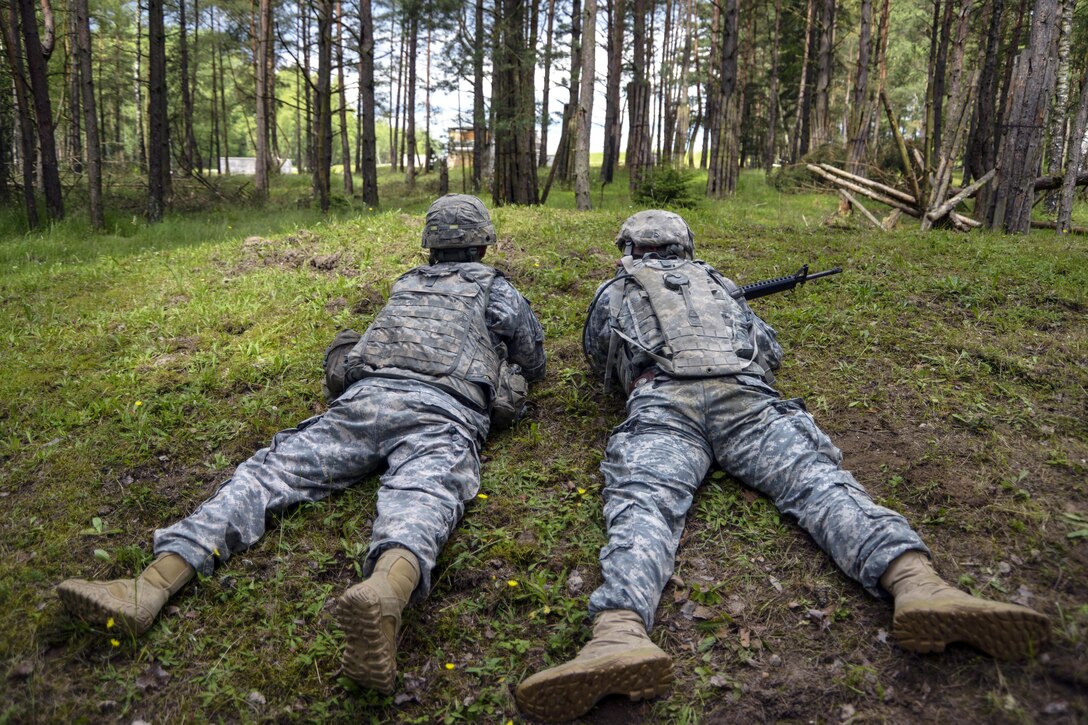 Soldiers look for the approach to engage targets during the Joint Multinational Training Command's Best Warrior Competition at the Grafenwoehr Training Area in Germany, June 22, 2016. The four-day competition challenged U.S. soldiers to prove their skills in military knowledge, leadership and endurance. Army photo by Christoph Koppers