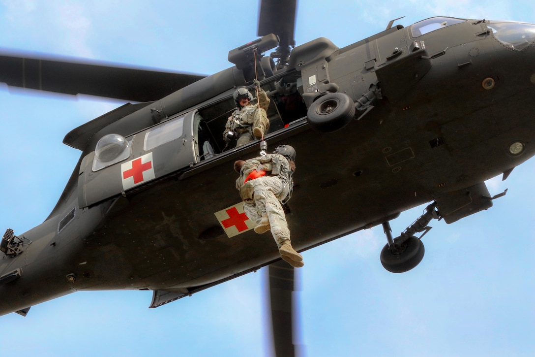 Army flight medics ascend on a hoist line with a simulated patient during medical evacuation training part of a joint exercise at Fort Bragg, N.C., June 23, 2016. The soldiers are assigned to the 82nd Airborne Division's 3rd Brigade Combat Team, 82nd Combat Aviation Brigade. Army photo by Sgt. Anthony Hewitt