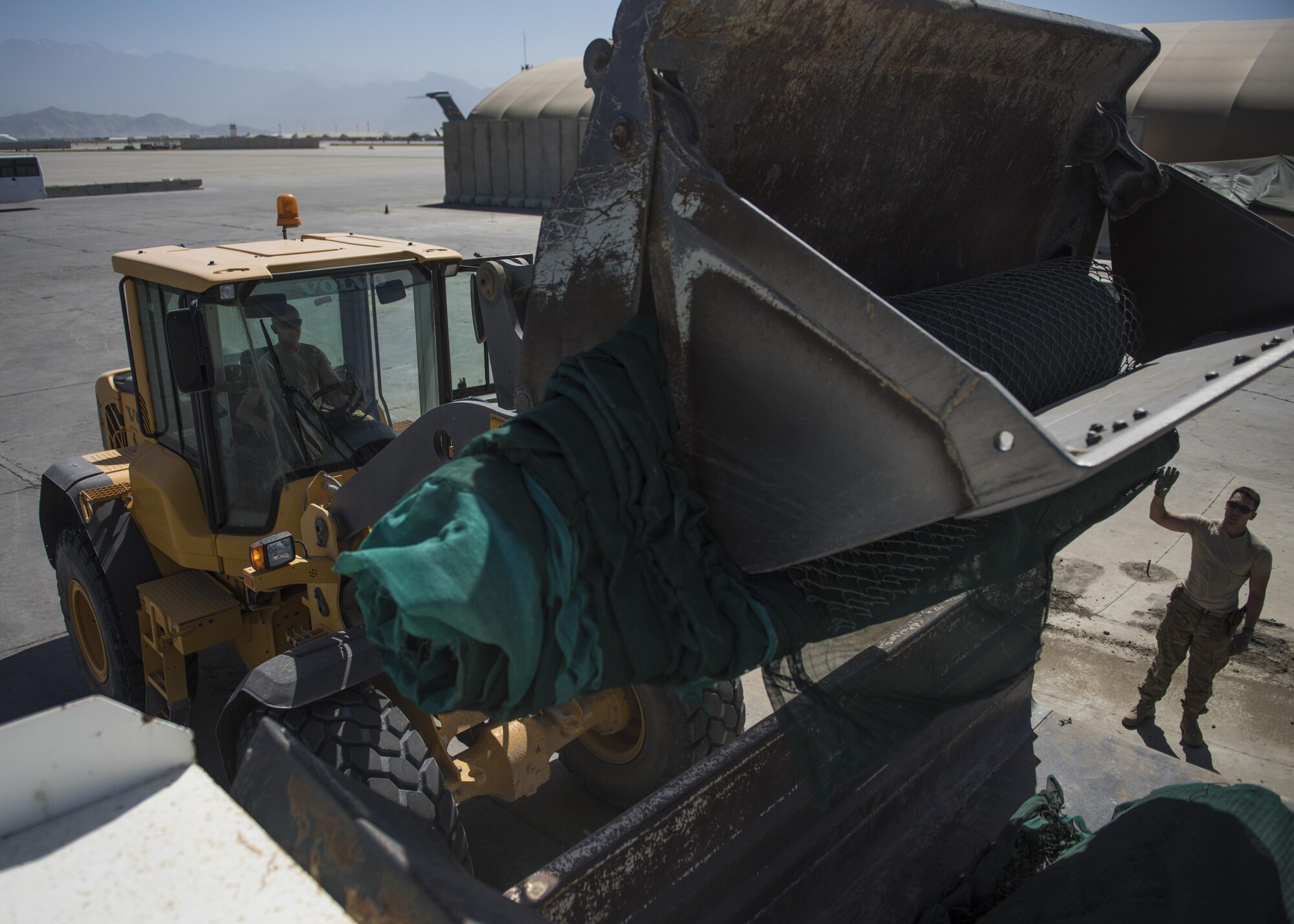 1st Lt. Mark Bohme (left), 455th Expeditionary Civil Engineer Squadron project engineer, moves a fence with the help of 1st Lt. Paul Dennison (right), 455th Expeditionary Civil Engineer Squadron flight chief, during a building demolition, June 22, 2016, Bagram Airfield, Afghanistan. Engineers a wide range of expertise from drafting, surveying and planning to explosive ordnance disposal and disaster preparedness. (U.S. Air Force photo by Senior Airman Justyn M. Freeman)