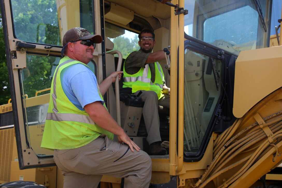 Casey Lazaruk, right, learns about heavy equipment operation from a Marine Corps Air Station Cherry Point Public Works Department employee during Protégé Day at MCAS Cherry Point, N.C., June 22, 2016. Protégé Day has been an annual event since it began in 2013. The purpose of Protégé Day is to give individuals with disabilities the opportunity to match up with professionals in their desired career fields for a day, in order to gain a better understanding of civilian jobs available aboard the air station. Lazaruk is a resident of the New Bern Vocational Rehabilitation Center. (U.S. Marine Corps photo by Lance Cpl. Mackenzie Gibson/Released)