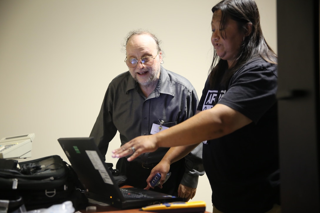 Thomas Gianatti, left, learns about computer software from Shyrel Windland during Protégé Day at Marine Corps Air Station Cherry Point, N.C., June 22, 2016. Protégé Day has been an annual event since it began in 2013. The purpose of Protégé Day is to give individuals with disabilities the opportunity to match up with professionals in their desired career fields for a day, in order to gain a better understanding of civilian jobs available aboard the air station. Gianatti is a resident of the New Bern Vocational Rehabilitation Center, and Windland is a field services contractor with the Cherry Point Telecommunications and Information Systems Department. (U.S. Marine Corps photo by Lance Cpl. Mackenzie Gibson/Released)
