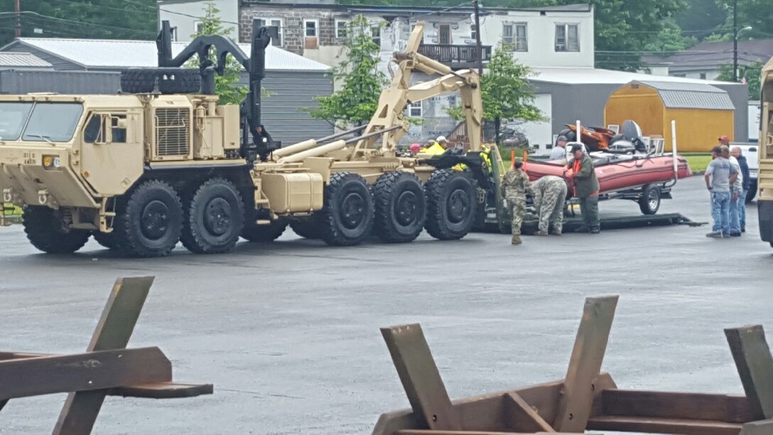 Members of the 811th Ordnance Company, 321st Ordnance Battalion, 38th Regional Support Group, perform rescue in partnership with local and state emergency first responders in the town of Rainelle, W.Va., following severe weather and flooding throughout the state 24 June, 2016.