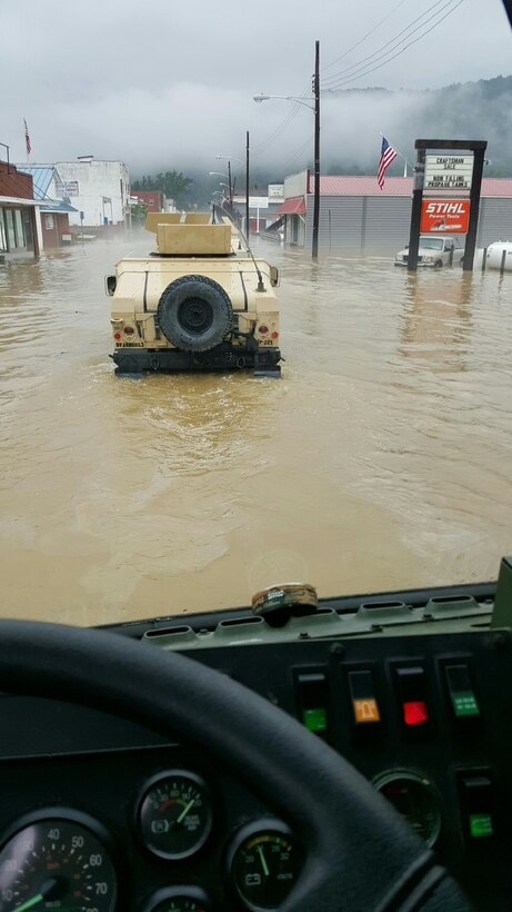 Members of the 811th Ordnance Company, 321st Ordnance Battalion, 38th Regional Support Group, perform rescue in partnership with local and state emergency first responders in the town of Rainelle, W.Va., following severe weather and flooding throughout the state 24 June, 2016.