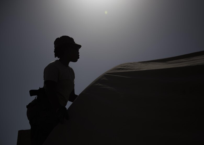 Airman 1st Class Taylor Davis, 455th Expeditionary Civil Engineer Squadron structural journeyman, ties down a tent cover to the skeleton, June 25, 2016, Bagram Airfield, Afghanistan. Structural specialists have a varied skill set that is used along with specialized materials, and equipment to build numerous structures that range from locker rooms to improvised emergency disaster relief shelters. (U.S. Air Force photo by Senior Airman Justyn M. Freeman)