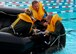 A 932nd Airlift Wing aircrew member helps pull his Airman into the raft as 932nd Operations Group pilots and aeromedical evacuation personnel trained in the rain during their last Unit Training Assembly weekend.  The event to develop proficiency during stress took place at the base pool to accomplish required water survival skills. The program simulates a plane needing to crash land in a remote water location, and the crew must then take care of each other using first aid skills, along with swimming, surviving and building shelter with the limited tools provided. (U.S. Air Force photos by Maj. Stan Paregien)