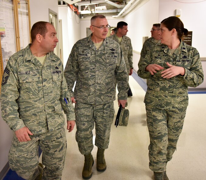 Chief Master Sgt. Lance Ott listens as the commander of the 932nd Airlift Wing, Col. Jonathan Philebaum, discusses long range maintenance issues with the commander of the 932nd Maintenance Group (MXG), Lt. Col. Amanda Sheets.  The MXG is responsible for leading people who are training and equipping Airmen to inspect, maintain and repair Air Force Reserve Command planes.  This MXG's management of resources improves the wing's professionalism and enables the 932nd Operations Group's C-40C aircraft to fly distinguished visitor (DV) airlift around the world.  In the background Command Chief Master Sgt. Chad Welch (left) and Senior Master Sgt. Todd Wadkins follow the tour.  Colonel Philebaum took several days to make the rounds and meet people throughout the Illinois unit, which is part of 22nd Air Force, under Air Force Reserve Command.  (U.S. Air Force photo by Tech. Sgt. Christopher Parr)