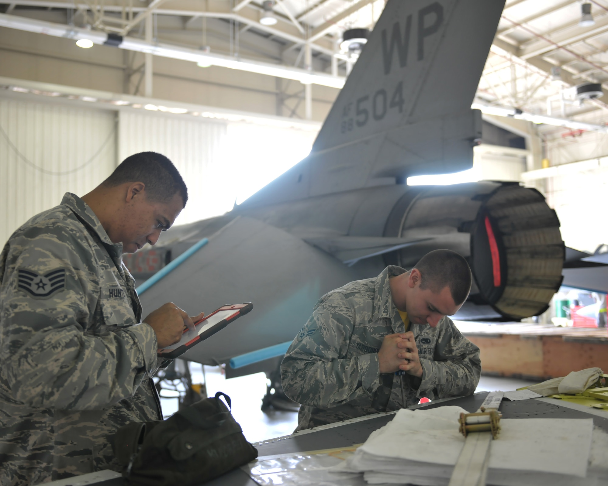 Staff Sgt. Dwight Hunter, 8th Aircraft Maintenance Squadron Aircraft Armament Systems team chief, oversees Airman 1st Class Ismael Fuentes Moran and Airman 1st Class Carson Yarborough, 8th AMXS Aircraft Armament Systems craftsmen, as they install a jettison release interface unit June 24, 2016 at Kunsan Air Base, Republic of Korea. Hunter and his team are working with other maintenance Air Force Specialty Codes on a simultaneous double wing replacement. (U.S. Air Force photo/Master Sgt. David Miller)