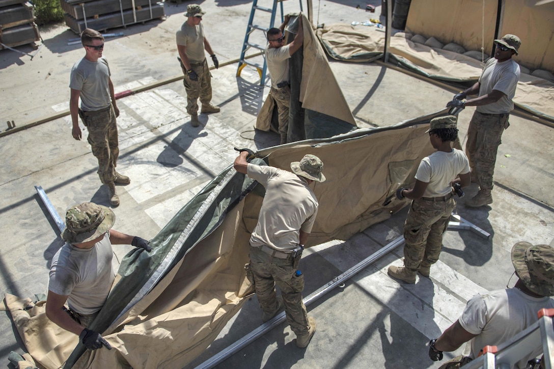 Airmen pull material while building a tent at Bagram Airfield, Afghanistan, June 25, 2016. Air Force photo by Senior Airman Justyn M. Freeman
