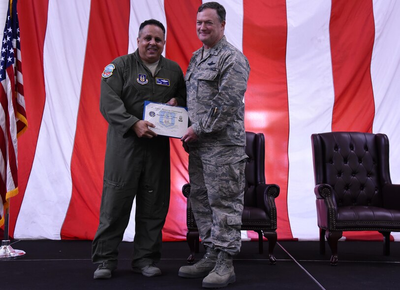 Master Sgt. Anthony "Taco" Cleaver, left, receives recognition from 514th Air Mobility Wing Commander, Col. David Pavey, during commander's call held Saturday. Cleaver earned a safety award for reaching 10,000 mishap free flying hours as a boom operator on the KC-10 tanker. (U.S. Air Force photo by Senor Airman Terry Clyburn II)