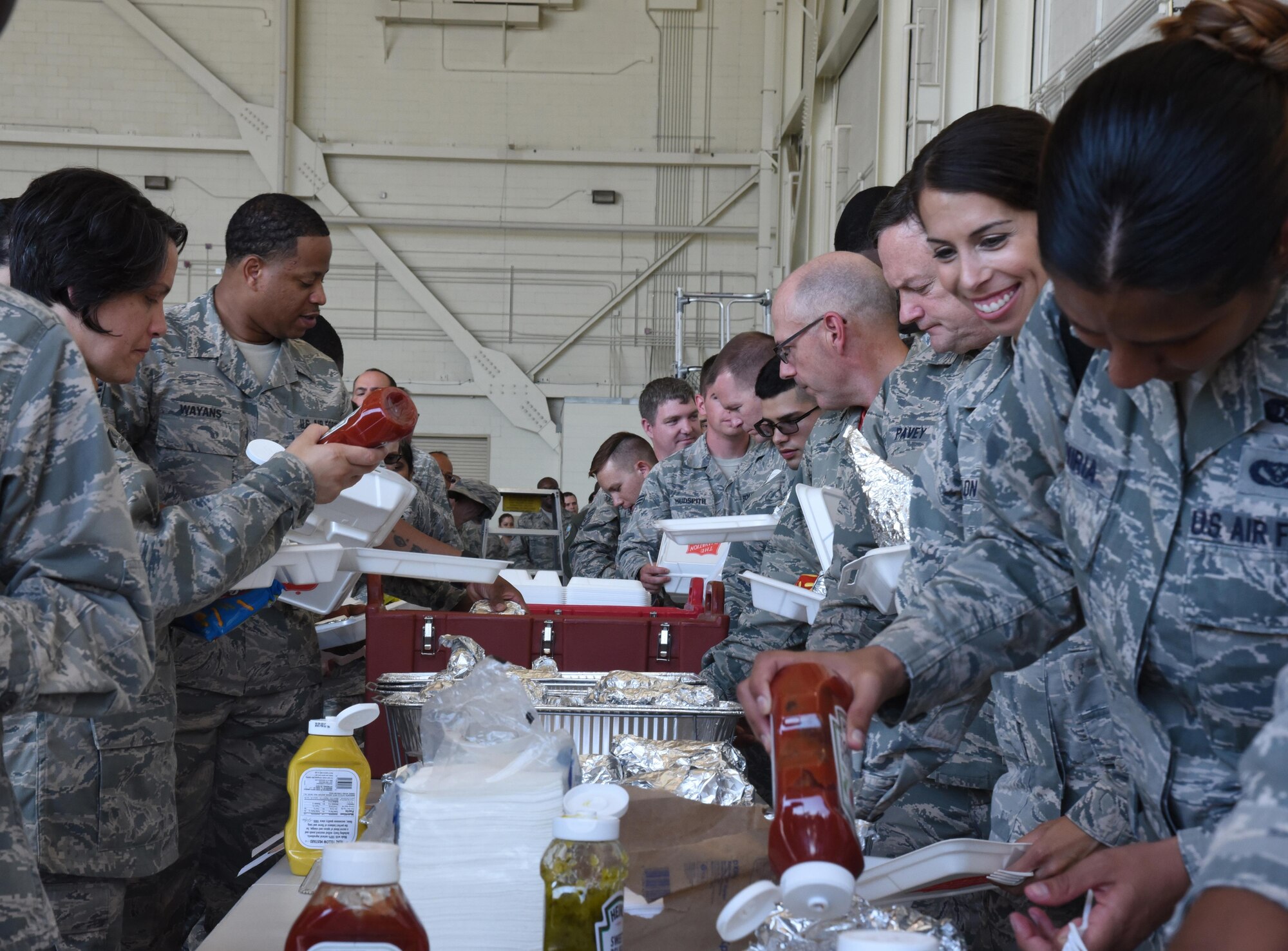 514th Air Mobility Wing members enjoy burgers and brats following Saturday's bi-annual commander's call held at Joint Base McGuire-Dix-Lakehurst, N.J. Col. David Pavey, commander and Command Chief Master Sgt. Kevin Warbrick recognized award winners, relayed command messages and thanked the wing's Reserve members for their continued military service during the bi-annual event. (U.S. Air Force photo by Senor Airman Terry Clyburn II)