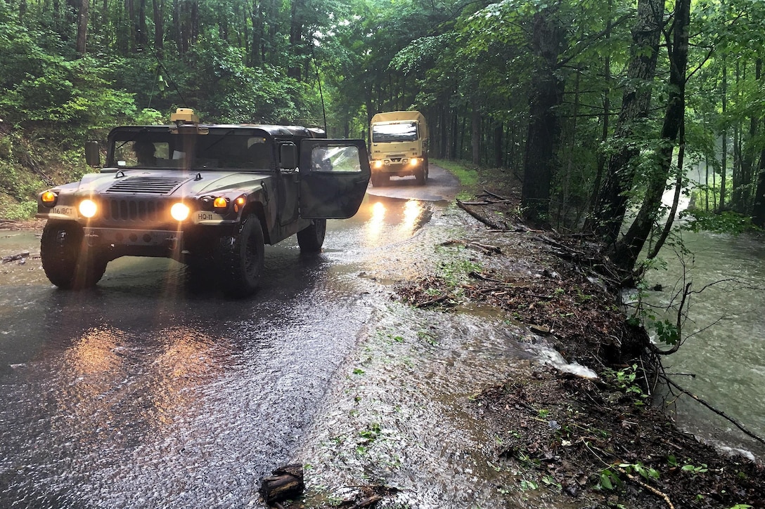 Soldiers drive vehicles along roadways to conduct damage assessments during severe flooding in Allegheny County, Va., June 24, 2016. Army National Guard photo by Alfred Puryear