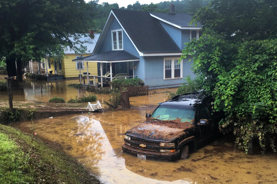 Floodwaters cover the ground in a neighborhood in Allegheny County, Va., June 24, 2016, as soldiers drive through the area to conduct damage assessments during severe flooding. Army National Guard photo by Alfred Puryear 