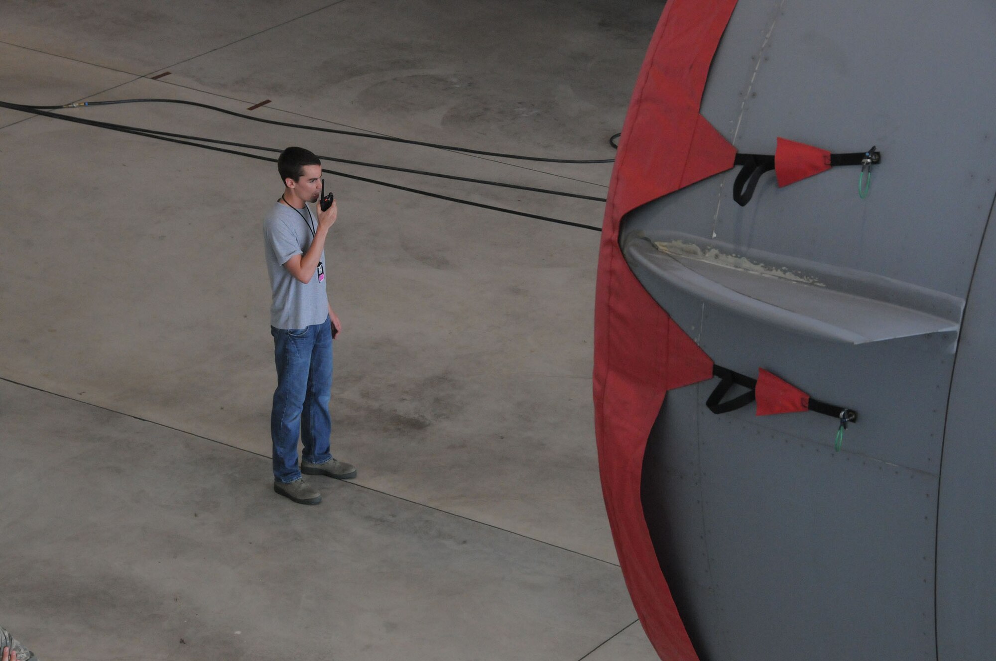 Senior Airman Barrett Lowry, a fuel systems mechanic with the 445th Aircraft Maintenance Squadron, makes a radio call to initiate base emergency responders to come to his location during the annual Confined Space Emergency Extraction Exercise at Wright-Patterson Air Force Base, Ohio June 21, 2016.  The exercise scenario was conducted to practice confined space self-rescue procedures in the extraction of an incapacitated airman from a long range fuel tank behind the #2 engine of a C-17 Globemaster III. (U.S. Air Force Photo by Tech. Sgt. Anthony G. Springer)