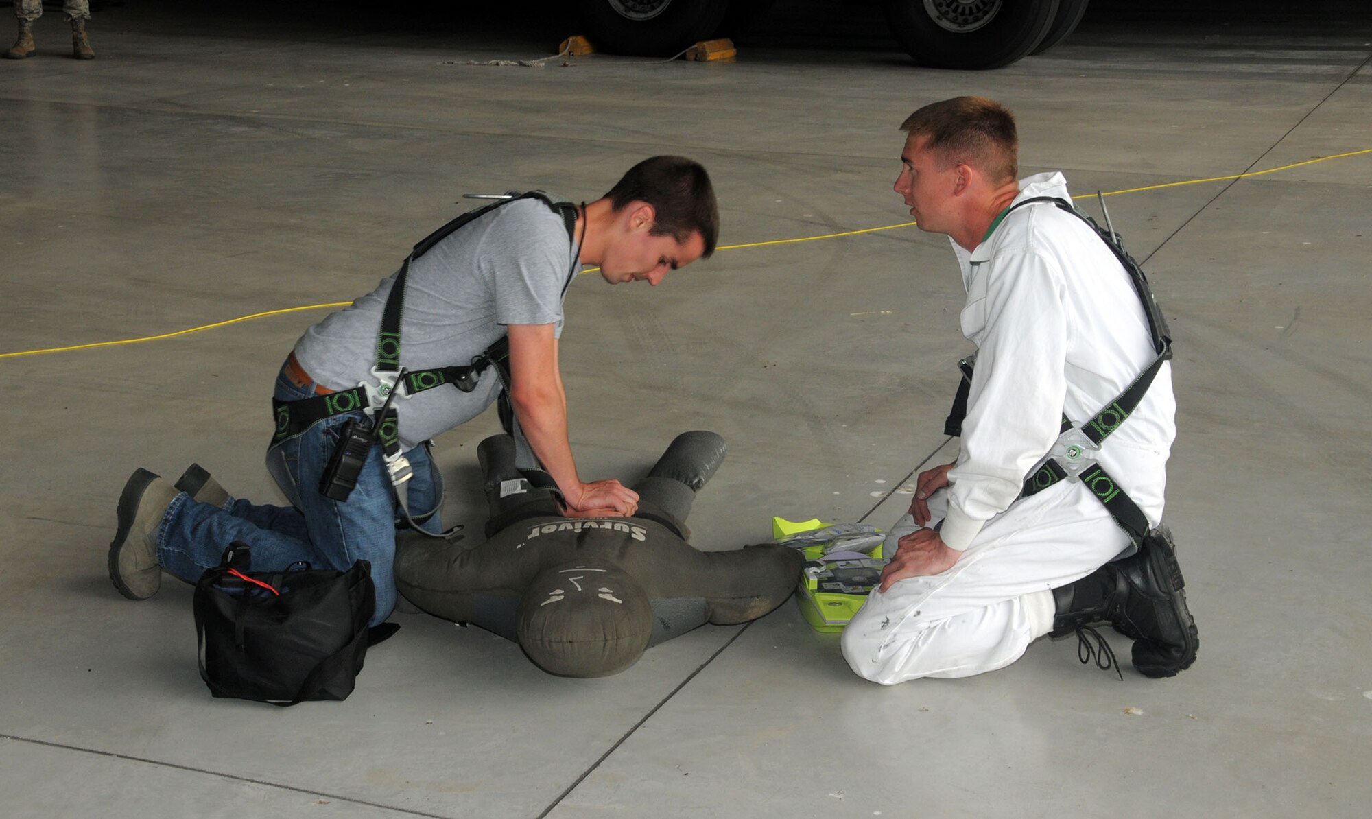 Senior Airman Barrett Lowry and Tech. Sgt. Jared Rucker, both fuel systems mechanics with the 445th Aircraft Maintenance Squadron simulate administering CPR to a training aid during the annual Confined Space Emergency Extraction Exercise at Wright-Patterson Air Force Base, Ohio June 21, 2016.  The exercise scenario was conducted to practice confined space self-rescue procedures in the extraction of an incapacitated airman from a long range fuel tank behind the #2 engine of a C-17 Globemaster III aircraft.    (U.S. Air Force Photo/Tech. Sgt. Anthony G. Springer)