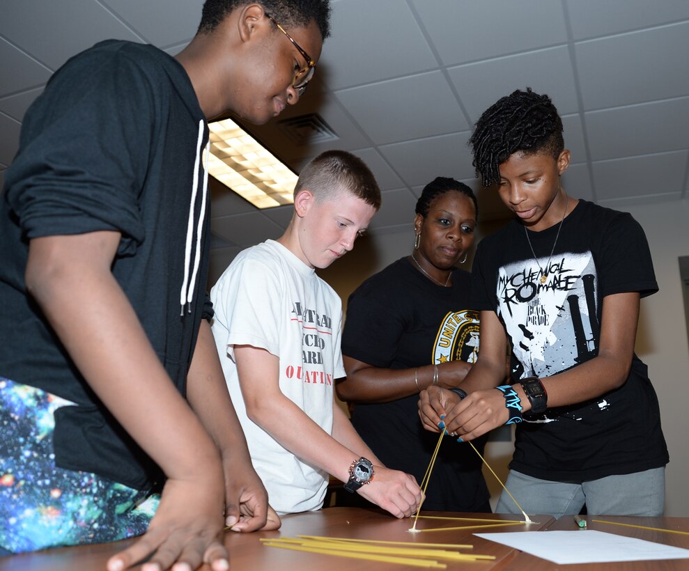 Marine Corps Logistics Base Albany youth and teens build a project using spaghetti noodles, 36-inches of tape and one marshmallow during the first annual Teen C.A.R.R.O.L.L. University summer camp here, June 15. Teen C.A.R.R.O.L.L. University facilitators taught youth skills designed to help shape their day-to-day activities as well as their future choices and career goals.