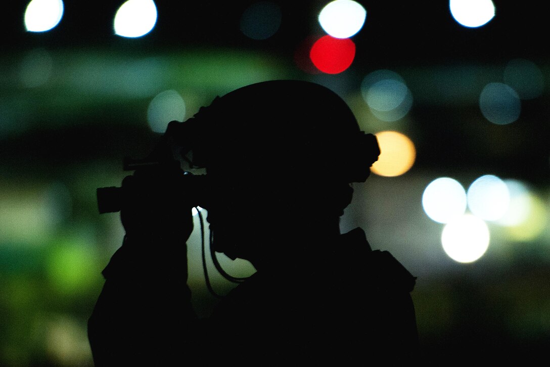 Air Force Tech. Sgt. Johnathan Silsley adjusts night vision goggles before driving an all-terrain vehicle during Exercise Swift Response 16 at Hohenfels, Germany, June 16, 2016. Silsley is an engineer assistant assigned to the 921st Contingency Response Squadron. More than 5,000 personnel from ten NATO nations participate in the crisis response exercise for multinational airborne forces. Air Force photo by Master Sgt. Joseph Swafford