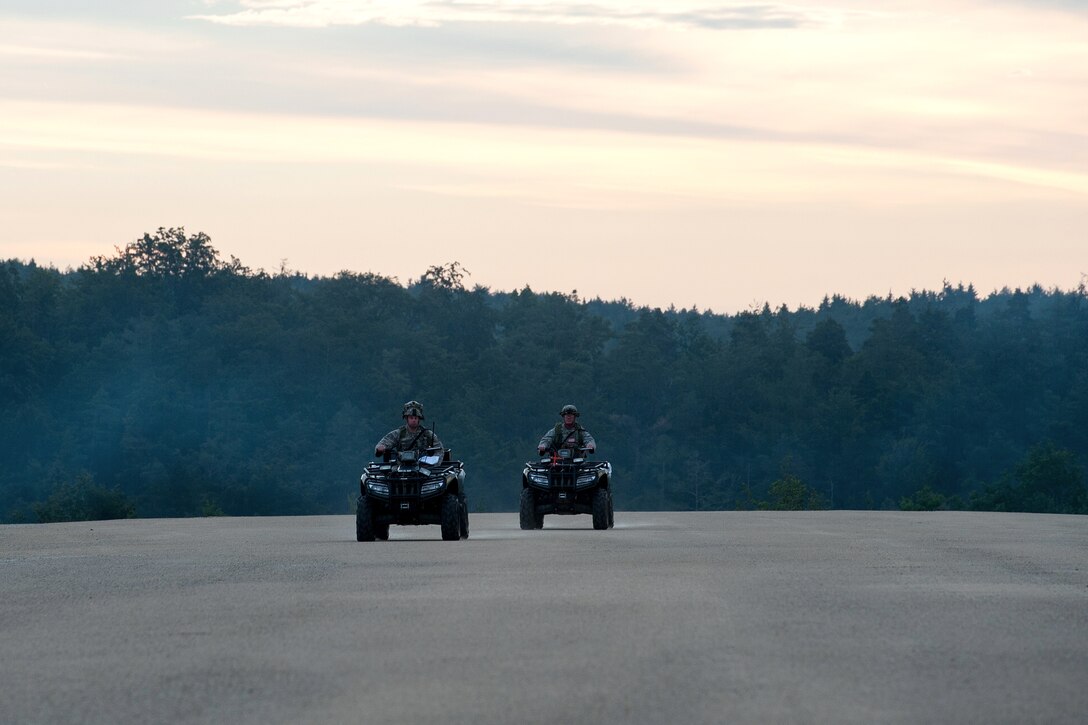 Air Force Staff Sgt. Andrew Meyer, left, and Air Force Master Sgt. Rodney Huffer conduct an airfield assessment from all-terrain vehicles during Exercise Swift Response 16 at Hohenfels, Germany, June 16, 2016. Meyer is an airfield manager and Huffer is an airfield assessment team ramp coordinator assigned to the 921st Contingency Response Squadron. Air Force photo by Master Sgt. Joseph Swafford 