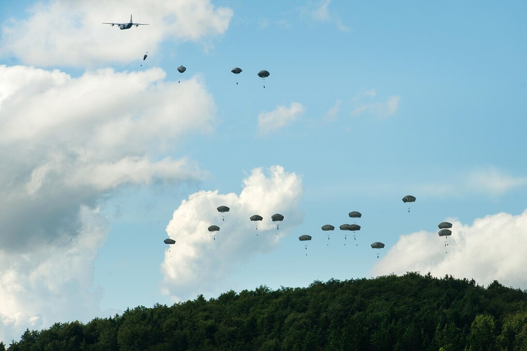 U.S. and NATO paratroopers jump from a U.S. Air Force C-130J Super Hercules onto the drop zone at Hohenfels, Germany during Exercise Swift Response 16, June 16, 2016. Air Force photo by Master Sgt. Joseph Swafford 