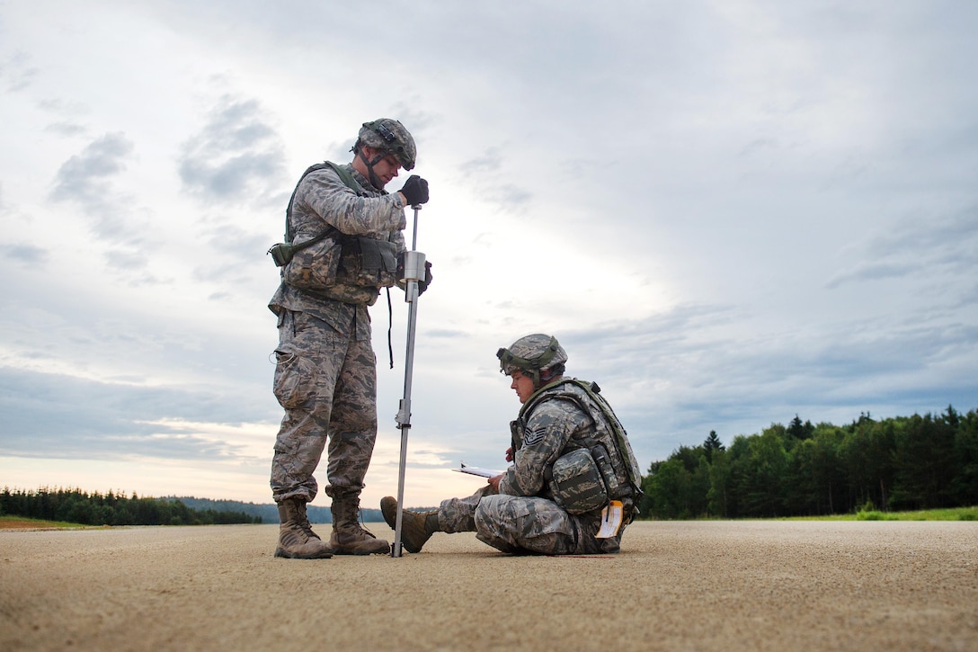 Air Force Capt. Jerry Carroll, left, and Air Force Tech. Sgt. Johnathan Silsley conduct an airfield assessment during Exercise Swift Response 16 at Hohenfels, Germany, June 16, 2016. Carroll is an engineer and Silsley is an engineer assistant, both assigned to the 921st Contingency Response Squadron. Air Force photo by Master Sgt. Joseph Swafford