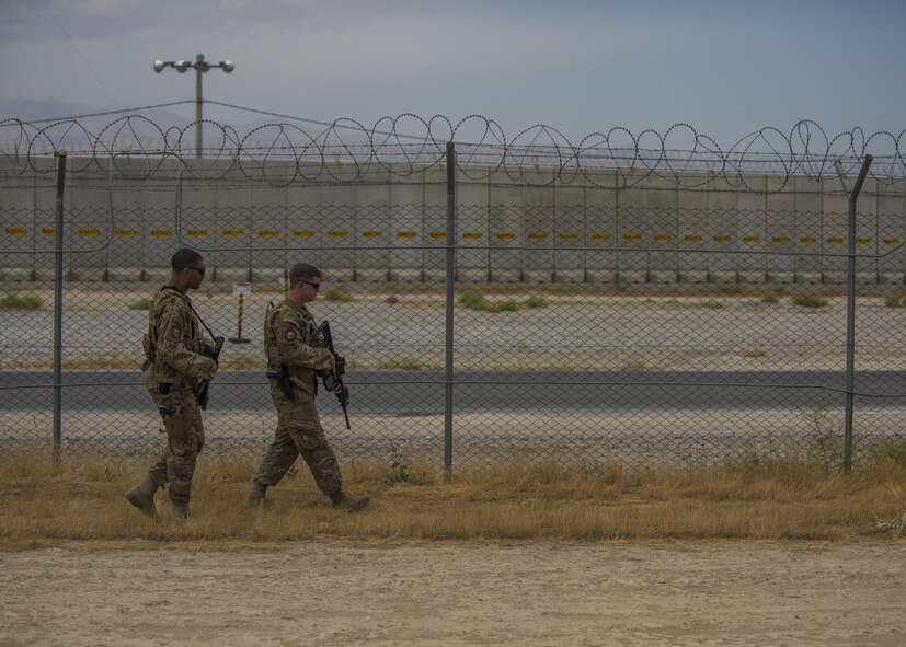 Staff Sgt. Gary Allsbrook (left) and Senior Airman Michael Van Deusen (right), 455th Expeditionary Security Forces Squadron quick reaction force (QRF), patrol the flightline perimeter, June 27, 2016, Bagram Airfield, Afghanistan. Objectives for members of the QRF is to establish a perimeter around the flightline during an indirect fire, allowing authorized personnel flightline access, and to make sure flightline operations continue uninterrupted. (U.S. Air Force photo by Senior Airman Justyn M. Freeman)