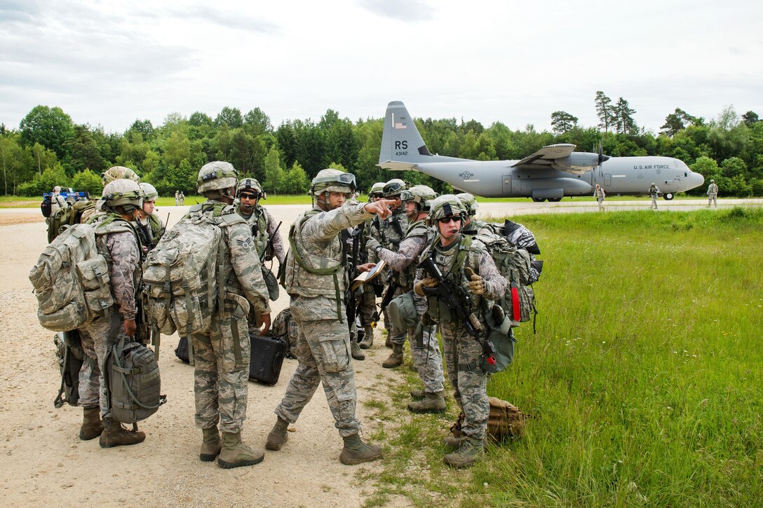 Air Force Staff Sgt. Byron Rice, center, directs fellow airmen during Exercise Swift Response 16 at Hohenfels, Germany, June 16, 2016. Rice is an airfield assessment team security forces member assigned to the 921st Contingency Response Squadron. Air Force photo by Master Sgt. Joseph Swafford 