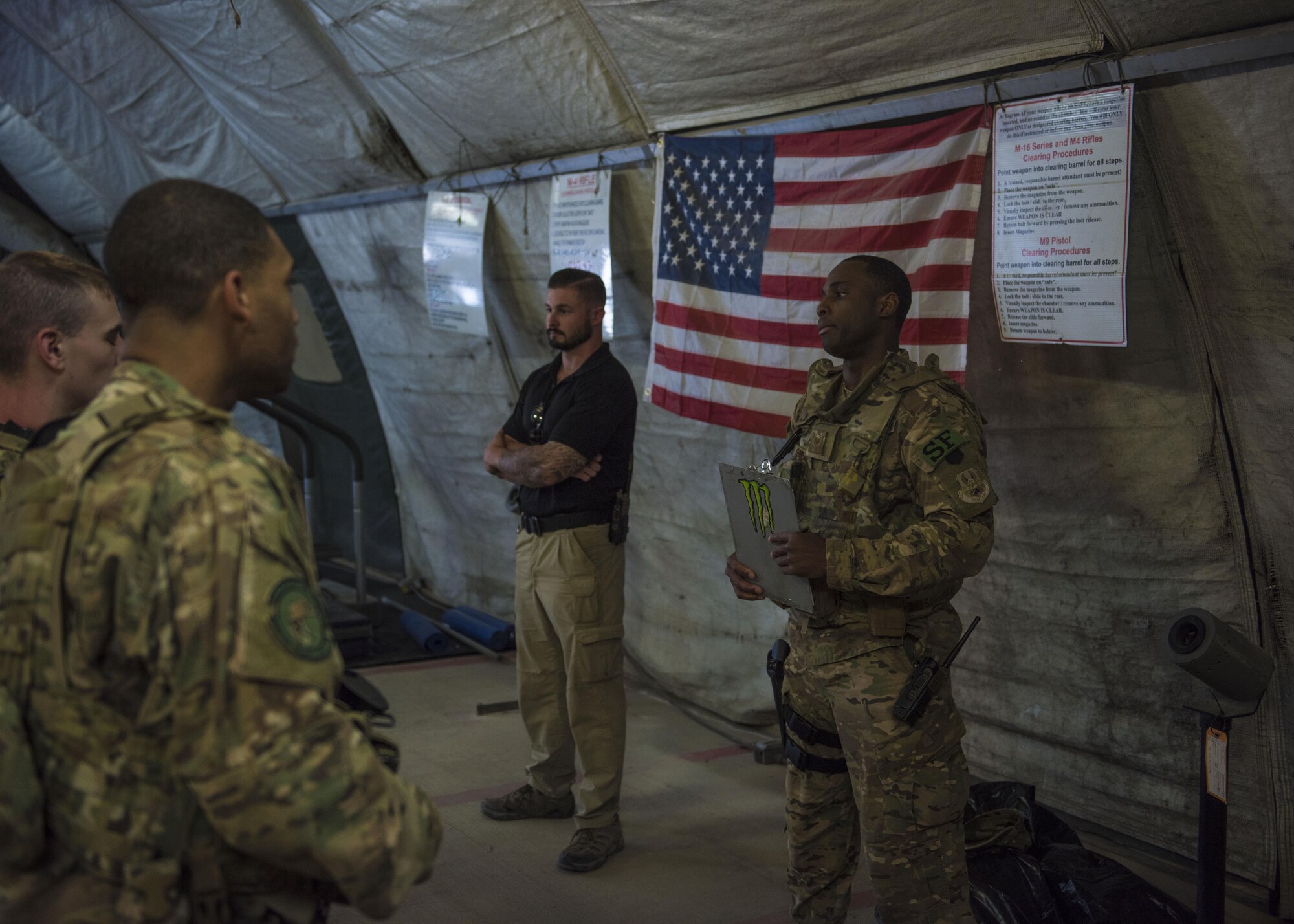 Staff Sgt. Duranta Gordon, 455th Expeditionary Security Forces Squadron quick reaction force, gives the guard mount briefing, June 27, 2016, Bagram Airfield, Afghanistan. Guard mount is conducted at the start of a shift. During guard mount, roll call is conducted for accountability and weapons and equipment inspections. (U.S. Air Force photo by Senior Airman Justyn M. Freeman)
