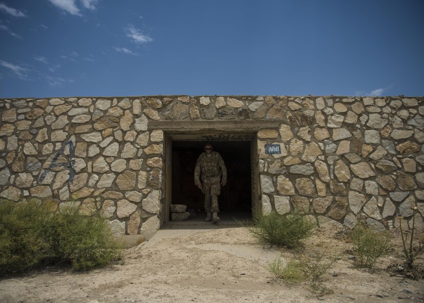 Staff Sgt. Gary Allsbrook, 455th Expeditionary Security Forces Squadron quick reaction force, walks out of an old bunker, June 27, 2016, Bagram Airfield, Afghanistan. Members of the 455th ESFS QRF teams check buildings and other areas on the flightline in order to deter threats. (U.S. Air Force photo by Senior Airman Justyn M. Freeman)