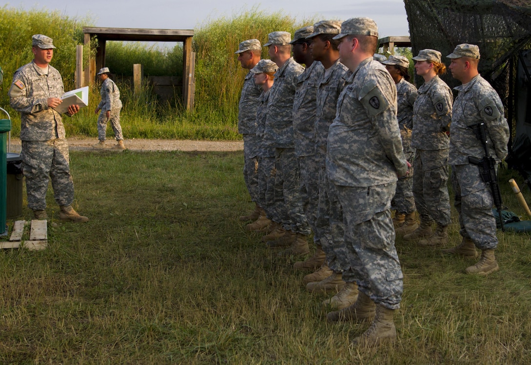 Sgt. Matthew Lewis, a U.S. Army Reserve culinary specialist from Springfield, Ohio, with the 391st Military Police Battalion, briefs his food service team on schedule for the the Philip A. Connelly Competition at Camp Atterbury, Indiana, June 23. The 391st is representing the 200th MP Command in the competition, part of a training program designed to improve professionalism and recognize excellence, which augments the quality of food and food service within the Army. The top four food service teams will continue to the U.S. Army Reserve level competition. (U.S. Army photo by Sgt. Audrey Hayes)