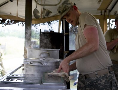 Spc. Sean Dubois, a U.S. Army Reserve culinary specialist from Euclid, Ohio, with the 391st Military Police Battalion, prepares to serve lunch during the Philip A. Connelly Competition at Camp Atterbury, Indiana, June 23. The 391st is representing the 200th MP Command in the competition, part of a training program designed to improve professionalism and recognize excellence, which augments the quality of food and food service within the Army. The top four food service teams will continue to the U.S. Army Reserve level competition. (U.S. Army photo by Sgt. Audrey Hayes)