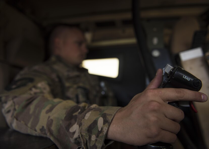 Senior Airman Jedsen Nunes, 455th Expeditionary Security Forces Squadron quick reaction force, operates a common remotely operated weapons station (CROWS), June 27, 2016, Bagram Airfield, Afghanistan. The CROWS system helps Airmen of the 455th ESFS QRF team conduct patrols and assists in monitoring the area they are operating in. (U.S. Air Force photo by Senior Airman Justyn M. Freeman)
