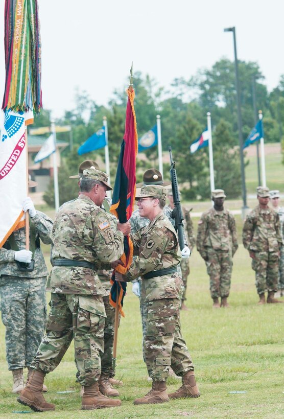 Maj. Gen. Mark McQueen, commander of the 108th Training Division (Initial Entry Training), takes the colors from Brig. Gen. Tammy Smith, commander of the 98th Training Division (IET), during a Relinquishment of Command Ceremony at Brave Rifles Parade Field on June 26. Smith, who has been in command of the Army Reserve division headquartered at Fort Benning since November 2015, will move to Korea to become the Deputy Commanding General of Sustainment for Eighth Army.