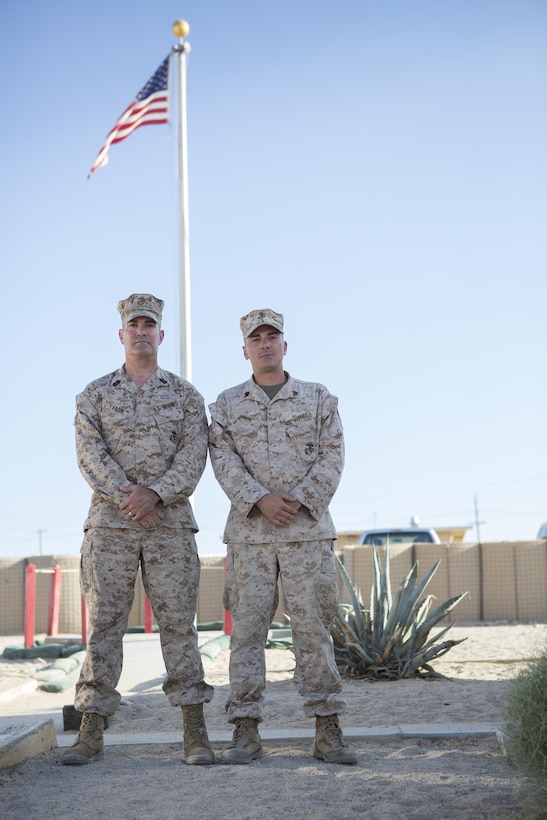 Marine Corps Master Gunnery Sgt. Mark A. Tyson, left, and his son, Marine Corps Sgt. Stephen A. Tyson, pose for a photo at Marine Corps Air Ground Combat Center Twentynine Palms, Calif., June 20, 2016. The father-son duo spent Father’s Day, June 19, 2016, together during Integrated Training Exercise 4-16. Marine Corps photo by Sgt. Sara Graham