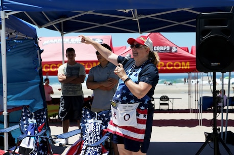 Christine Winicki addresses Marines, Sailors and family members of Combat Logistics Battalion 5, 1st Marine Logistics Group, at a family appreciation event hosted by volunteers from Saddleback Church and Marine Corps Camp Services aboard Camp Pendleton, Calif., June 17, 2016. Winicki is the Battalion family readiness officer. Aside from offering service members and their families some time to come together and relax, the event supported the 101 Days of Summer Campaign, which aims to promote increased safety during the summer months. (U.S. Marine Corps Photos by Sgt. Carson Gramley/released)