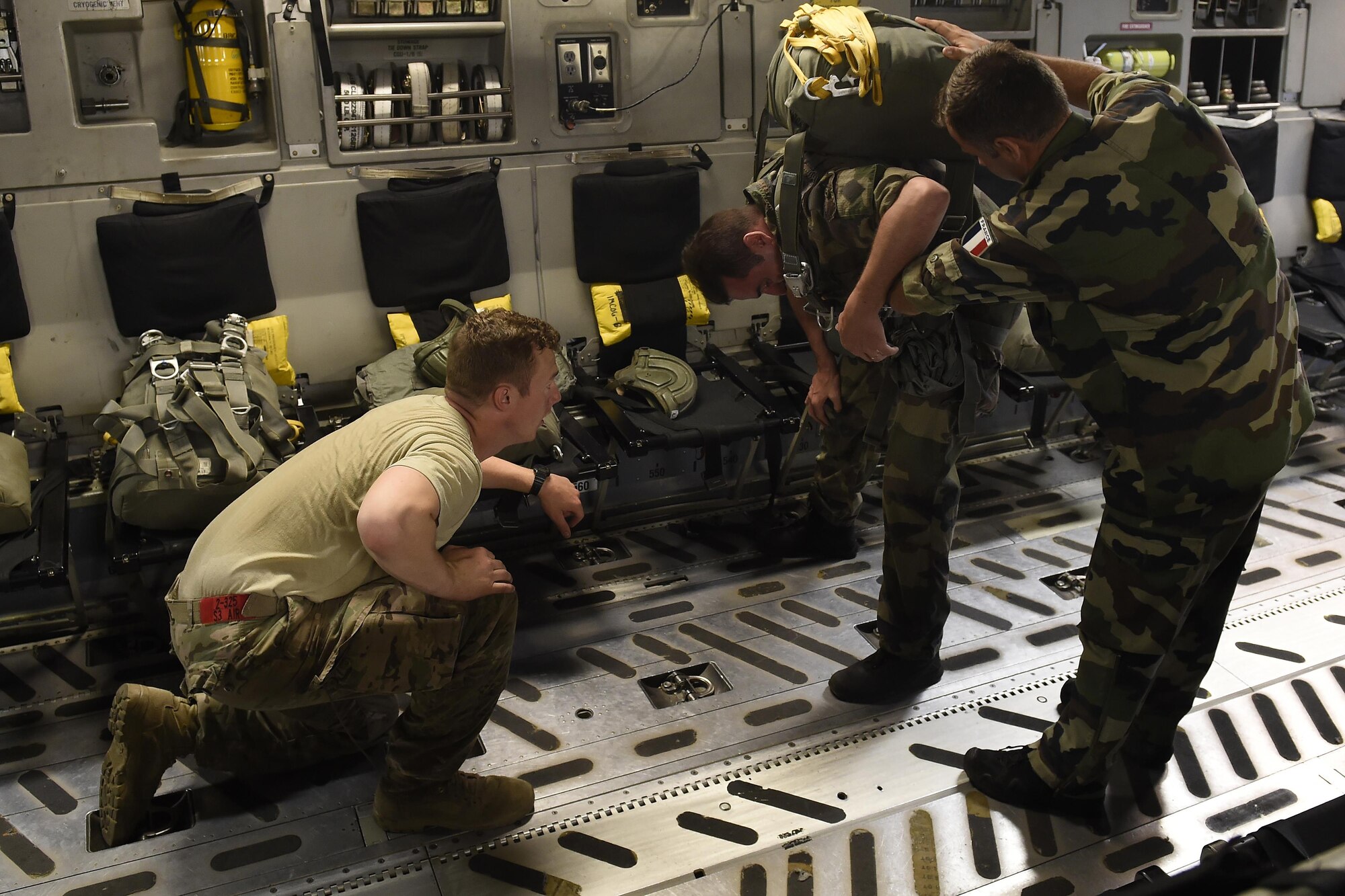 1st Lt. Michael Richardson, 82nd Airborne Division Fort Bragg, N.C. observes French paratroopers preparing their chutes for a static line jump June 22, 2016, near Libreville, Gabon Africa during Central Accord 2016. U.S. Army Africa's exercise Central Accord 2016 is an annual, combined, joint military exercise that brings together partner nations to practice and demonstrate proficiency in conducting peacekeeping operation.  (U.S. Air Force photo/Tech. Sgt. Tim Chacon)