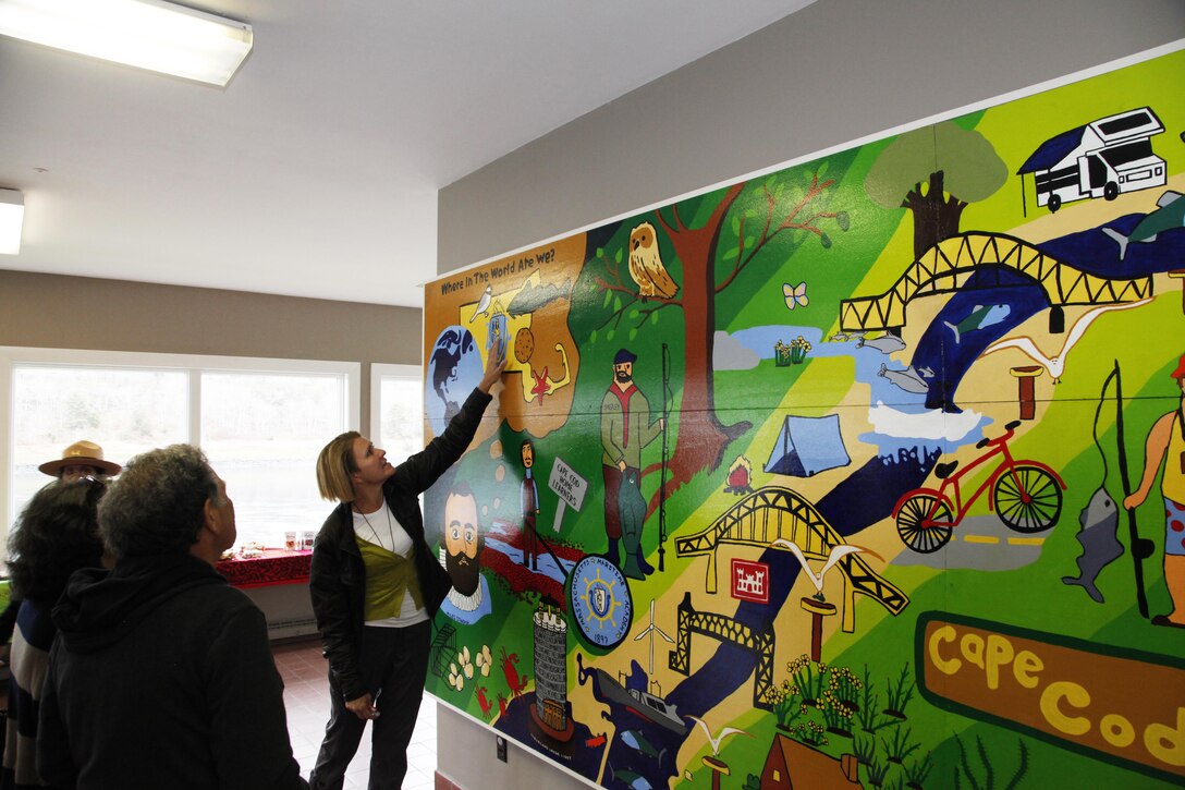 Lauren Freed, Cape Cod Learners Cooperative, examines the mural that her students painted and donated to the New England District on May 1, 2016.