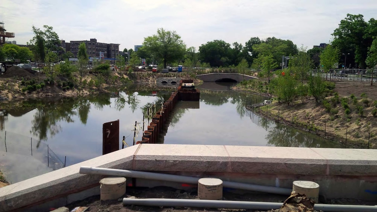 Filling of the left side (looking downstream) of the FRM channel is complete, awaiting the extraction of the river diversion sheeting. Note that both banks have been planted; and plantings will continue. Note also the footings for the permanent steel handrail at the culvert headwall.