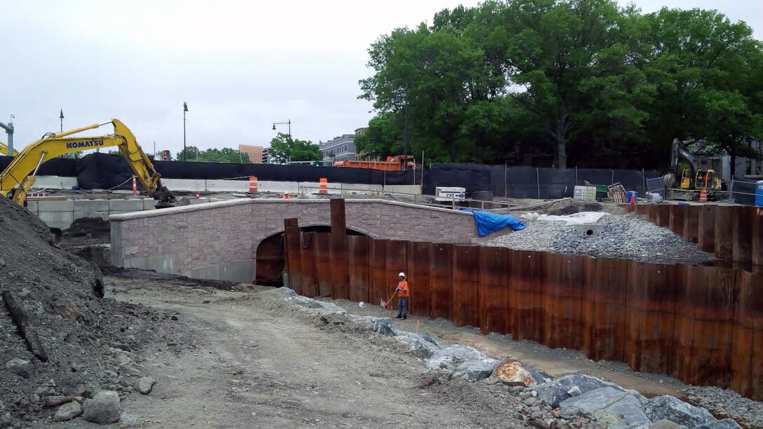 Granite veneer installed and continued backfilling behind the wing wall and shaping of the Flood Risk Management (FRM) channel on the northside.

The Muddy River Flood Risk Management (FRM) & Environmental Restoration Phase 1 Construction Project is located in between the Riverway downstream to Avenue Louis Pasteur. The major project components involve the installation of a 10-foot by 24-foot box culvert under Riverway, the installation of 10-foot by 24-foot box culvert under Brookline Avenue, daylighting of the area between Riverway and Brookline Avenue, and daylighting of the area between Brookline Avenue and Avenue Louis Pasteur. Daylighting is the removal of existing twin 72" culverts and excavation of the area to return the waterway to a natural state.