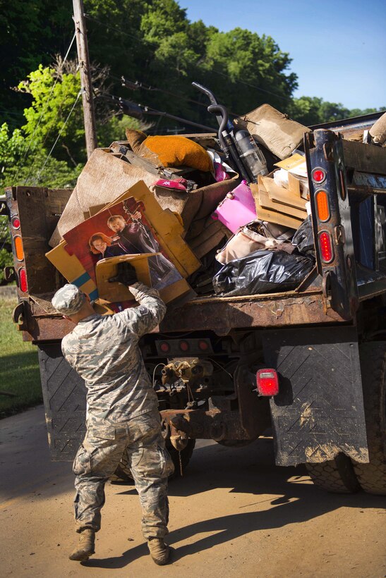 Air Force Tech. Sgt. Brian Grim loads debris onto a truck in Clendenin, W.Va., June 26, 2016, while assisting with flood response efforts. Grim is assigned to the West Virginia Air National Guard’s 167th Airlift Wing. Air National Guard photo by Tech. Sgt. De-Juan Haley