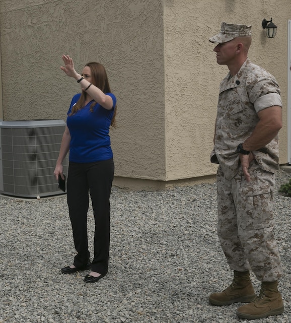 Leslie May, Palm District manager, Lincoln Military Housing, explains to Sgt. Maj. Michael J. Hendges, Combat Center Sergeant Major, the new exterior features of newly-renovated housing units  aboard the Marine Corps Air Ground Combat Center, Twentynine Palms, Calif.,  June 21, 2016. (Official Marine Corps photo by Lance Cpl. Dave Flores/Released)