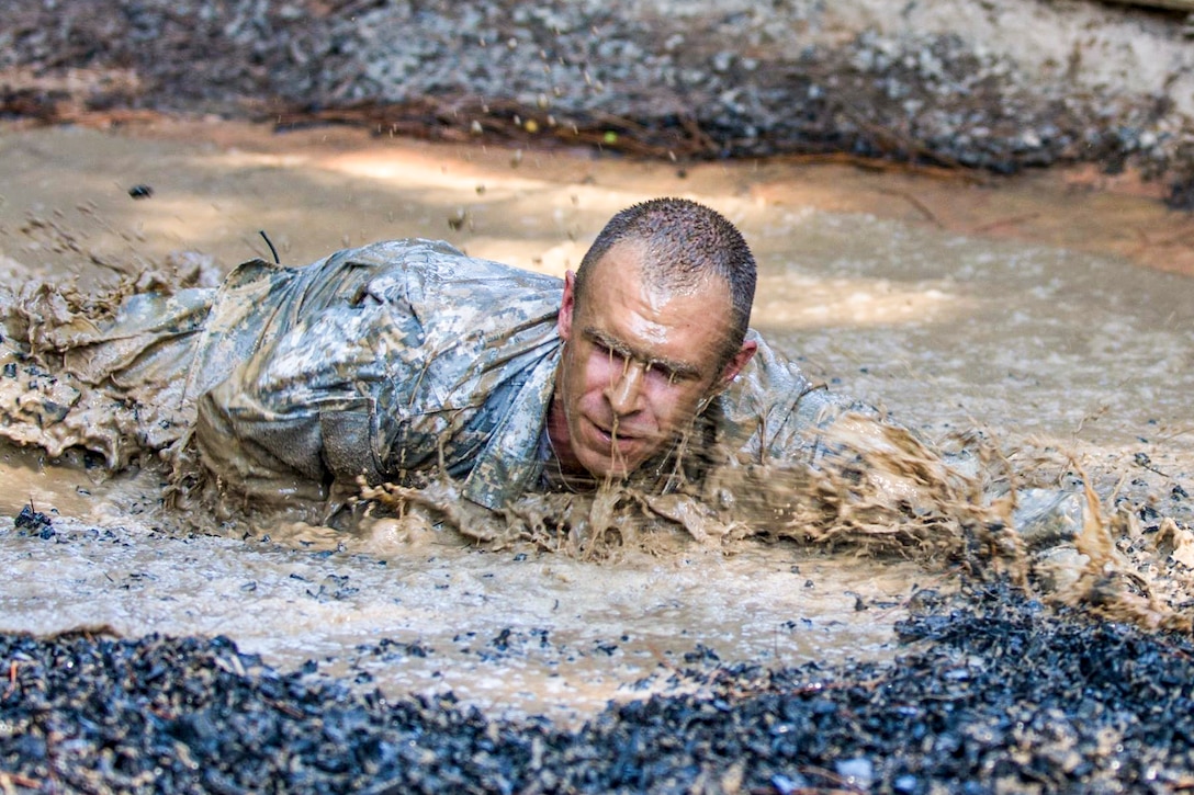 A candidate tackles a mud pit obstacle on the fit-to-win endurance course at the ‪Drill Sergeant Academy in Fort Jackson, S.C., June 17, 2016. Candidates spend 63 training days in the course preparing to become drill sergeants for the Army's four basic combat training posts. Army photo by Sgt. 1st Class Brian Hamilton