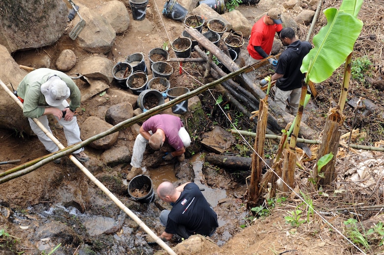 Joe Griffin (top left), senior archeologist for the U.S. Army Corps of Engineers, observes as members of his team from the Defense POW/MIA Accounting Agency collect soil samples to be examined during site excavation in the Xiangkhoang Province, Lao People’s Democratic Republic.  Members of the DPAA deployed to the area in hopes of recovering the remains of a pilot unaccounted for since the Vietnam War era. (DoD photo by Staff Sgt. Jocelyn Ford, USAF/RELEASED)