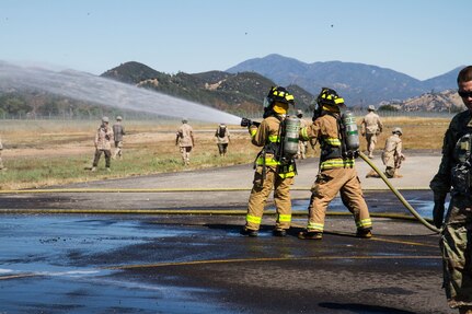 U.S. Army firefighting Soldiers participating in the WAREX training exercises hosted by 91st Training Division respond to a downed helicopter scenario on Fort Hunter Liggett, Calif. on May 9, 2016. Fire response Soldiers put out a fire in the training helicopter as medical units treat casualties. (U.S. Army photos by 1LT Kevin Braafladt 91st Training Division Public Affairs/Released)   #91TD2016WAREX