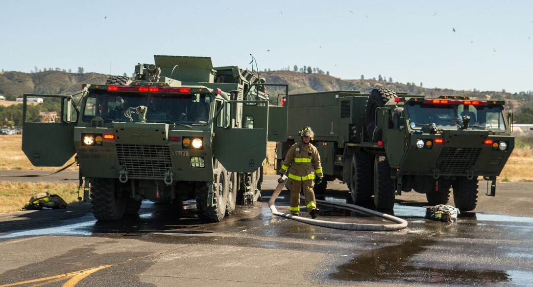 U.S. Army firefighting Soldiers participating in the WAREX training exercises hosted by 91st Training Division respond to a crashed helicopter scenario at Fort Hunter Liggett, Calif. on May 9, 2016. Fire crews responded to put out a fire and treat wounded during a training exercise. (U.S. Army photos by 1LT Kevin Braafladt 91st Training Division Public Affairs/ Released) #91TD2016WAREX