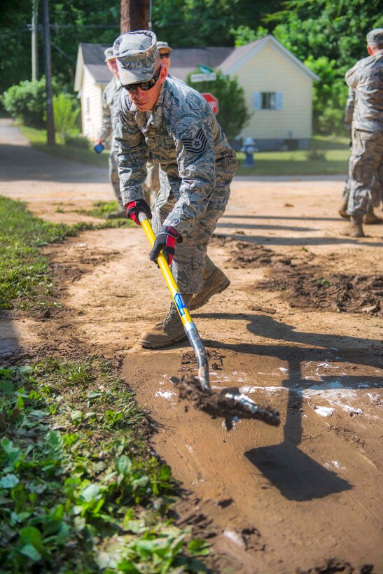 Air Force Tech. Sgt. Caleb Brown shovels mud and debris during flood cleanup in Clendenin, W.Va., June 26, 2016. Brown is assigned to the West Virginia Air National Guard’s 130th Airlift Wing. Air National Guard photo by Tech. Sgt. De-Juan Haley